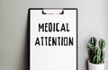 MEDICAL ATTENTION inscription on clipboard with holder. Health care concept Royalty Free Stock Photo
