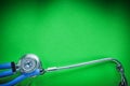 Medical auscultator for checkup on green background Royalty Free Stock Photo