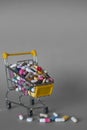 Medical background or concept. Close-up of a shopping trolley filled with colorful pills. Cart from the supermarket with different Royalty Free Stock Photo