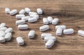 White tablets or pills on wooden table. Medicine and pharmacy Royalty Free Stock Photo