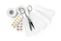 Medical bandage rolls, pills, sticking plaster and scissors on white background, top view Royalty Free Stock Photo