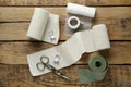 Medical bandage rolls, sticking plaster and scissors on wooden background, flat lay Royalty Free Stock Photo