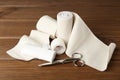 Medical bandage rolls, sticking plaster and scissors on wooden table Royalty Free Stock Photo