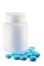 Medical blue pills and white bottle on white isolated background. Concept of healthcare and medicine. Royalty Free Stock Photo