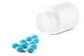 Medical blue pills and white bottle on white isolated background. Concept of healthcare and medicine. Royalty Free Stock Photo