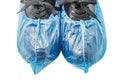 Medical blue shoe covers are worn on black shoes, part, front view, isolated on white background with clipping path