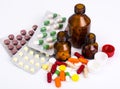 Medical bottles and foil blisters with the capsules and tablets Royalty Free Stock Photo