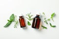 Medical bottles and herbs on white background, top view