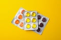 Medical candies in blister packs on yellow background