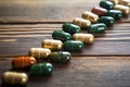 medical cannabis pills laid out in a row on a wooden surface