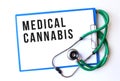 MEDICAL CANNABIS text on a medical folder and stethoscope on white background