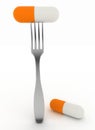 Medical capsule on dinner fork Royalty Free Stock Photo