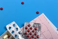 Medical cardiology concept. Heart health pills and cardiogram on a blue background. ECG. Copy space Royalty Free Stock Photo