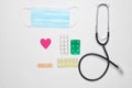 Medical cardiology equipment on a white background. Stethoscope, tablet, pills. Medical concept, top view, flat lay style.