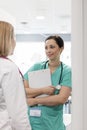 Nurse holding clipboard while discussing with doctor at hospital Royalty Free Stock Photo
