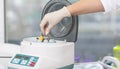 Medical centrifuge. Scientist loading a sample to centrifuge machine in the medical or scientific laboratory Royalty Free Stock Photo