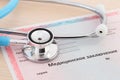 Medical certificate form. Getting or replacing a driver`s license. Stethoscope lying on a medical document. Translation of the