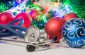 Medical Christmas and New Year photo - stethoscope or phonendoscope are located near balls for Christmas tree in blurry background
