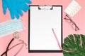 Medical clipboard, stethoscope, monstera sheet, goggles and face shield on a pink background. Medical banner template with copy Royalty Free Stock Photo