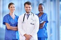 Medical, collaboration and portrait of doctor with nurses standing in a corridor of the hospital. Confidence, diversity Royalty Free Stock Photo