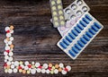 Medical colorful pills on isolated on wooden background