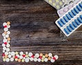 Medical colorful pills on isolated on wooden background