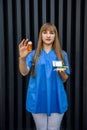 Medical concept. Beautiful young nurse in blue uniform holds pills Royalty Free Stock Photo
