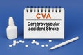 On a blue background, a pen, tablets and a notepad with the inscription - CVA Cerebrovascular accident Stroke