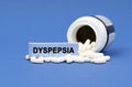 On a blue surface lies a jar of pills and a sign with the inscription - DYSPEPSIA