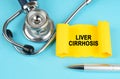 On the blue surface there is a stethoscope, a pen and a yellow sticker with the inscription - Liver cirrhosis