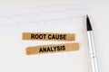 On the cardiogram lies a pen and torn paper with the text - Root Cause Analysis