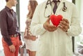 Medical concept about cardiology. doctor holding a plastic icon heart