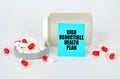 On a gray background, a jar, capsules and a sign with the inscription - High Deductible Health Plan