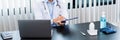 Medical concept a male doctor wearing a mask writing prescription to patient at his modern clinic for recovering from Coronavirus Royalty Free Stock Photo