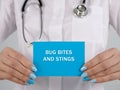 Medical concept meaning BUG BITES AND STINGS with phrase on the piece of paper Royalty Free Stock Photo