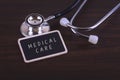 Medical Concept- MEDICAL CARE words written on label tag with Stethoscop Royalty Free Stock Photo