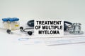 On the medical documents there is a stethoscope, syringe and a business card with the inscription - treatment of multiple myeloma