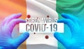 Medical Concept of pandemic Coronavirus COVID-19 outbreak with backgroung of waving national flag of Cote Ivoire Royalty Free Stock Photo