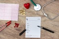 Medical concept - Pharmacy receipt, stethoscope, heart, syringe and cardiogram