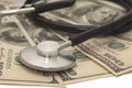 Medical concept - stethoscope over the dollar bills Royalty Free Stock Photo