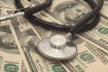 Medical concept - stethoscope over the dollar bills Royalty Free Stock Photo