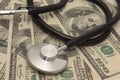 Medical concept - stethoscope over the dollar bills Royalty Free Stock Photo