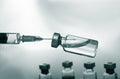 Medical concept Vaccination vaccine vial dose flu shot drug needle syringe. Green color filter