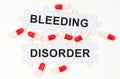 On a white surface, tablets and puzzles with the inscription - Bleeding Disorder