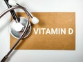 Medical concept.Word VITAMIN D on brown paper with stethoscope. Royalty Free Stock Photo