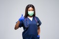 Medical concept of young beautiful female doctor with protective face mask, waist up. Woman hospital worker looking at camera and Royalty Free Stock Photo