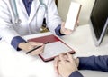 Medical consultation by docter with note. Royalty Free Stock Photo