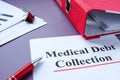 Medical debt collection papers and red folder. Royalty Free Stock Photo