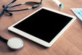 Medical desk with digital tablet and stethoscope. Blank for message