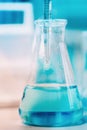 Medical details - Doctor testing probes with pipette in glass container. Close up of scientist using technology